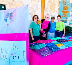 PuRR Project volunteers standing behind the table with all the items for sale