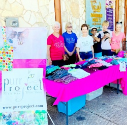 Volunteers posing at the Purr table